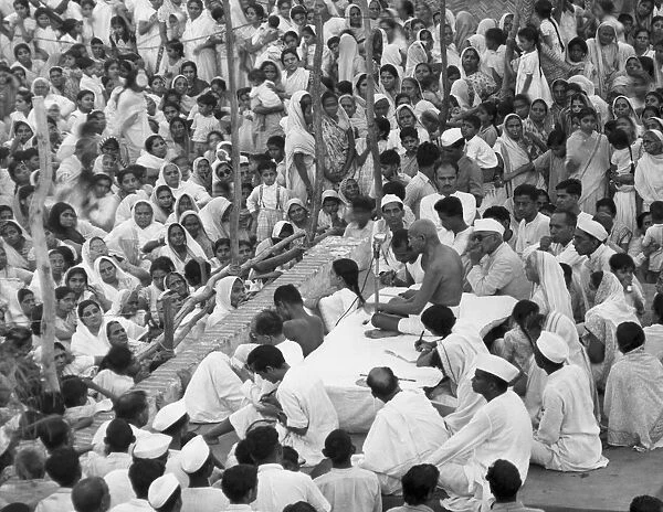 Gandhi speaking in front of large crowd