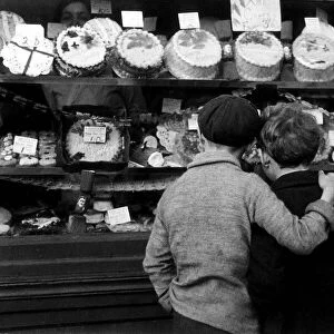 Children look into a bakery shop window, February 1935